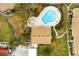Aerial view of pool area with lush landscaping, adjacent buildings, and convenient access paths at 7606 Woodbridge Blvd, Tampa, FL 33615