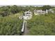 Aerial view of a waterfront property with a dock, house, pool, and lush greenery at 8117 Bay Dr, Tampa, FL 33635
