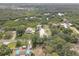 Birds-eye-view of the property with surrounding lush greenery and ample parking at 8117 Bay Dr, Tampa, FL 33635