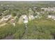 Aerial view showcasing a waterfront property with in-ground pool, dock, and surrounded by lush vegetation at 8117 Bay Dr, Tampa, FL 33635