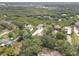 Property aerial view with spacious yards, lush greenery, and mature trees offering privacy at 8117 Bay Dr, Tampa, FL 33635
