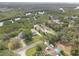 Aerial view showcasing the home and surrounding area with mature trees and lush vegetation at 8117 Bay Dr, Tampa, FL 33635