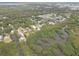 Aerial view showcasing the property in a neighborhood close to canals and surrounded by lush vegetation at 8117 Bay Dr, Tampa, FL 33635