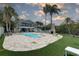 Expansive backyard featuring a sparkling pool, lush landscaping, and inviting outdoor spaces at 8117 Bay Dr, Tampa, FL 33635