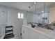 Bathroom with double sinks, marble counters, large mirror, and a glass enclosed shower providing a spa-like experience at 8117 Bay Dr, Tampa, FL 33635