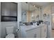 Bright bathroom featuring a double sink vanity, modern lighting, and mosaic tile backsplash at 8117 Bay Dr, Tampa, FL 33635