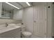 Bathroom featuring a vessel sink, tile flooring, and a toilet with a white door at 8117 Bay Dr, Tampa, FL 33635