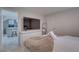 Bright bedroom with a TV on a dresser, a view into the kitchen and neutral-toned decor at 8117 Bay Dr, Tampa, FL 33635