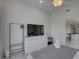 Bedroom showcasing a sleek dresser, TV, ceiling fan, and tranquil view to an adjacent room for seamless transitions at 8117 Bay Dr, Tampa, FL 33635