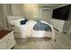 Cozy bedroom with a comfortable bed, white dresser, and soft, natural light at 8117 Bay Dr, Tampa, FL 33635