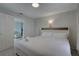 Cozy bedroom features a queen-sized bed, neutral linens, and a view into the living area at 8117 Bay Dr, Tampa, FL 33635