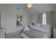 Bedroom boasts a gray tiled floor, king bed, ample natural light, and a door leading to an adjacent space at 8117 Bay Dr, Tampa, FL 33635