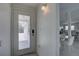 Bright entryway with a modern door leading to a dining area with a kitchen beyond, offering a welcoming ambiance at 8117 Bay Dr, Tampa, FL 33635