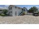 Two-story home featuring a brick driveway, a garage, staircase and a well-kept yard at 8117 Bay Dr, Tampa, FL 33635