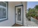 Private entrance features a glass door and is surrounded by a glass railing with a view of a pool at 8117 Bay Dr, Tampa, FL 33635