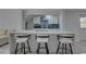 Modern kitchen with a white countertop island and stylish barstools at 8117 Bay Dr, Tampa, FL 33635