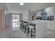 Bright open concept kitchen with new appliances and view of the living area and pool at 8117 Bay Dr, Tampa, FL 33635