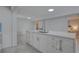 Open concept kitchen with white cabinets, stainless steel appliances, and a breakfast bar at 8117 Bay Dr, Tampa, FL 33635
