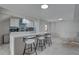 Bright kitchen with blue backsplash, stainless appliances, and stylish white barstools at the island at 8117 Bay Dr, Tampa, FL 33635