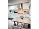 Well-lit kitchen with white cabinets, stainless steel appliances, and a dining area at 8117 Bay Dr, Tampa, FL 33635