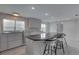 Modern kitchen boasts white cabinetry, stylish backsplash, stainless appliances, and breakfast bar seating at 8117 Bay Dr, Tampa, FL 33635
