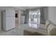 Bright living room offers a view of the outdoor fireplace, tile floors, and neutral decor at 8117 Bay Dr, Tampa, FL 33635