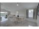 Sun-filled living area featuring neutral decor, a dining area, and outdoor views at 8117 Bay Dr, Tampa, FL 33635