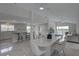 Open-concept living room boasts a dining area, modern kitchen, and sliding glass doors for seamless indoor-outdoor living at 8117 Bay Dr, Tampa, FL 33635
