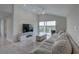 Bright living room featuring high ceilings, neutral decor, tile flooring, and sliding glass doors to a patio at 8117 Bay Dr, Tampa, FL 33635