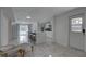 Bright open concept living area and kitchen with new flooring, modern furniture and poolside view at 8117 Bay Dr, Tampa, FL 33635