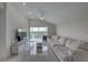 Light-filled living space with vaulted ceiling, neutral tones, and expansive windows overlooking the yard at 8117 Bay Dr, Tampa, FL 33635