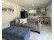 Comfortable living space with a plush sofa, modern kitchen, and stylish dining area at 8117 Bay Dr, Tampa, FL 33635
