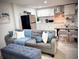 Comfortable living space with a plush sofa, modern kitchen, and stylish dining area at 8117 Bay Dr, Tampa, FL 33635