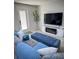 Cozy living room featuring a plush sofa, entertainment center, and sleek design at 8117 Bay Dr, Tampa, FL 33635