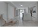 Bright open concept living area and kitchen with new flooring, modern furniture and poolside view at 8117 Bay Dr, Tampa, FL 33635