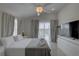 Bright main bedroom with ample natural light, a ceiling fan, and sliding doors leading to a balcony at 8117 Bay Dr, Tampa, FL 33635