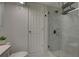 Walk-in shower featuring glass door, tile surround, and overhead shower head at 8117 Bay Dr, Tampa, FL 33635