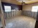Bedroom with cement flooring and two windows ready for renovation and your finishing touches at 8422 Boxwood Dr, Tampa, FL 33615