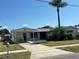 Charming single story home with palm tree, covered entrance, and well manicured front lawn at 8422 Boxwood Dr, Tampa, FL 33615