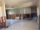 Open living space with ceramic tile flooring, wall paneling, and ready for renovation at 8422 Boxwood Dr, Tampa, FL 33615