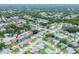 Sprawling aerial view of a vibrant residential neighborhood with mature trees and diverse architectural styles at 8913 Welsh Way, Hudson, FL 34667