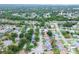 Wide aerial view showing a residential area with lush greenery and varied home styles, including a home with a pool at 8913 Welsh Way, Hudson, FL 34667