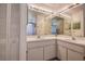Well-lit bathroom featuring double sinks, spacious mirrors, and ample counter space at 8913 Welsh Way, Hudson, FL 34667