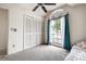 Carpeted bedroom featuring a vaulted ceiling, a large arched window, and a spacious closet at 8913 Welsh Way, Hudson, FL 34667