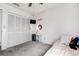 Cozy bedroom with a closet, gray carpeting, and a modern ceiling fan at 8913 Welsh Way, Hudson, FL 34667