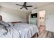Comfortable bedroom with a ceiling fan, wood floors, and an ensuite bathroom at 8913 Welsh Way, Hudson, FL 34667