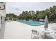 Inviting community pool surrounded by lounge chairs and lush greenery, perfect for relaxing and socializing at 8913 Welsh Way, Hudson, FL 34667