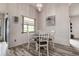 Dining room with hardwood floors, neutral paint and a designer light fixture at 8913 Welsh Way, Hudson, FL 34667