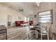Spacious dining room with hardwood floors, modern light fixture, and dining table set at 8913 Welsh Way, Hudson, FL 34667