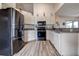 Bright kitchen features sleek black appliances, white cabinetry, and granite countertops at 8913 Welsh Way, Hudson, FL 34667